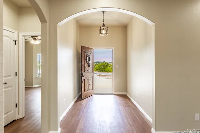 a view of a hallway view with wooden floor and staircase