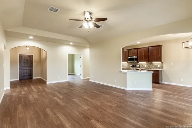 a view of a kitchen with a sink and dishwasher a kitchen view with wooden floor