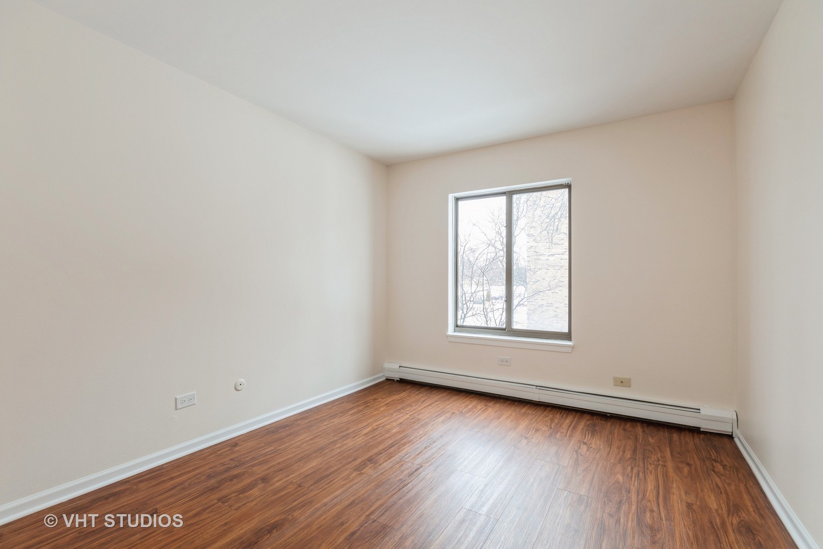 1919 Prairie Square, Unit 133 Schaumburg, IL 60173 - Photo 12 of 14 an empty room with wooden floor and window