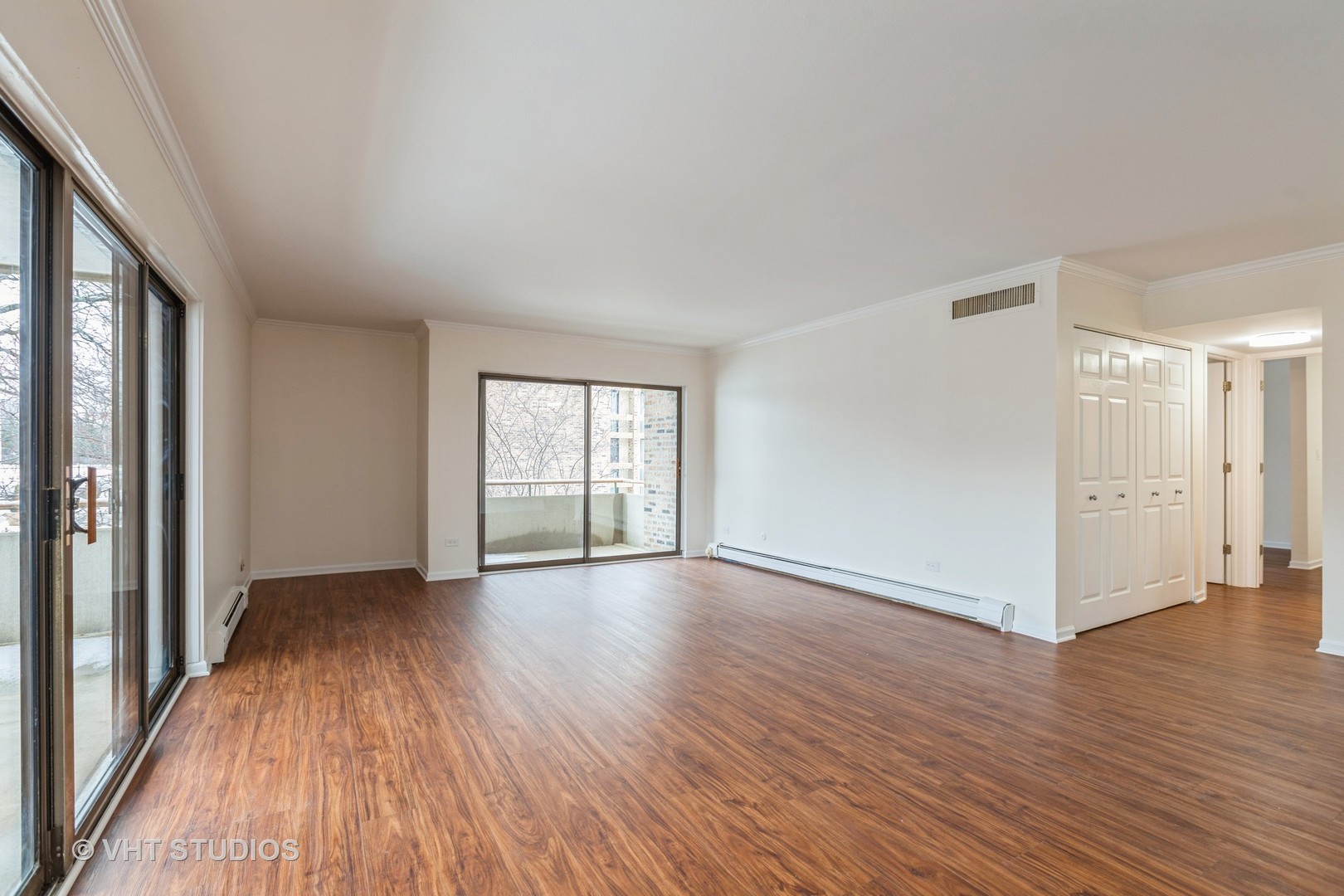 1919 Prairie Square, Unit 133 Schaumburg, IL 60173 - Photo 4 of 14 a view of an empty room with wooden floor and a window