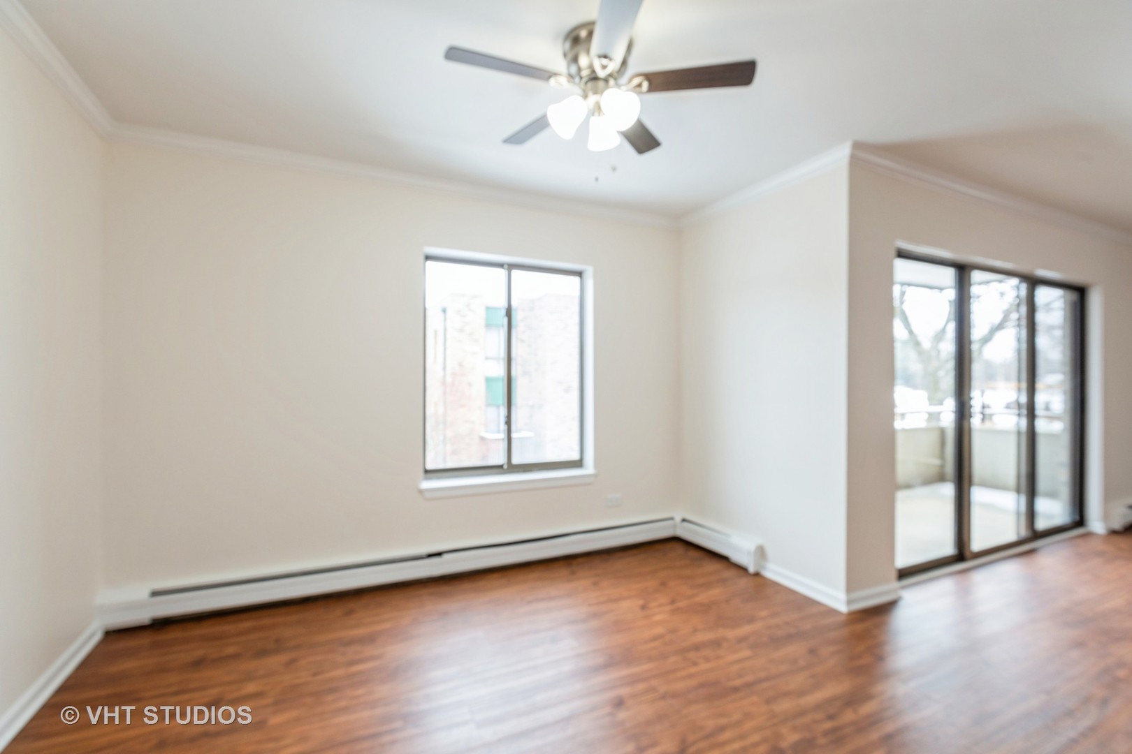 1919 Prairie Square, Unit 133 Schaumburg, IL 60173 - Photo 5 of 14 an empty room with wooden floor and windows
