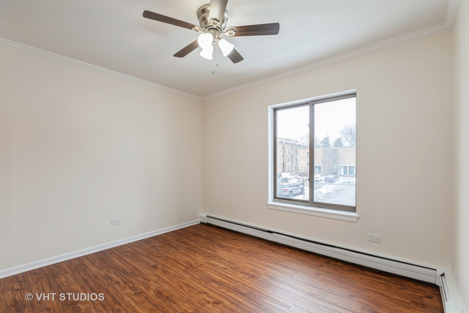1919 Prairie Square, Unit 133 Schaumburg, IL 60173 - Photo 6 of 14 an empty room with wooden floor chandelier fan and windows