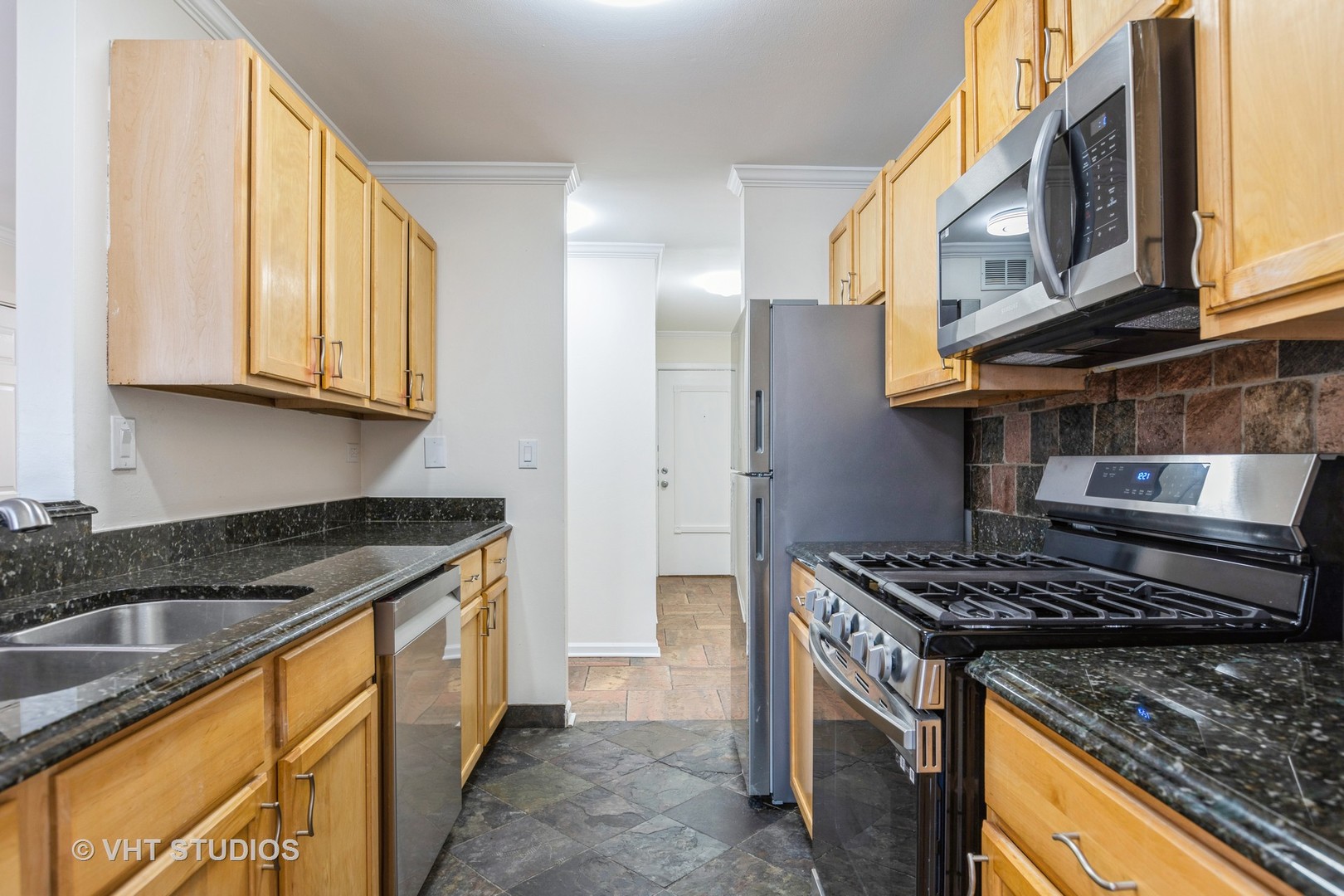 1919 Prairie Square, Unit 133 Schaumburg, IL 60173 - Photo 7 of 14 a kitchen with stainless steel appliances granite countertop a stove a sink and a microwave