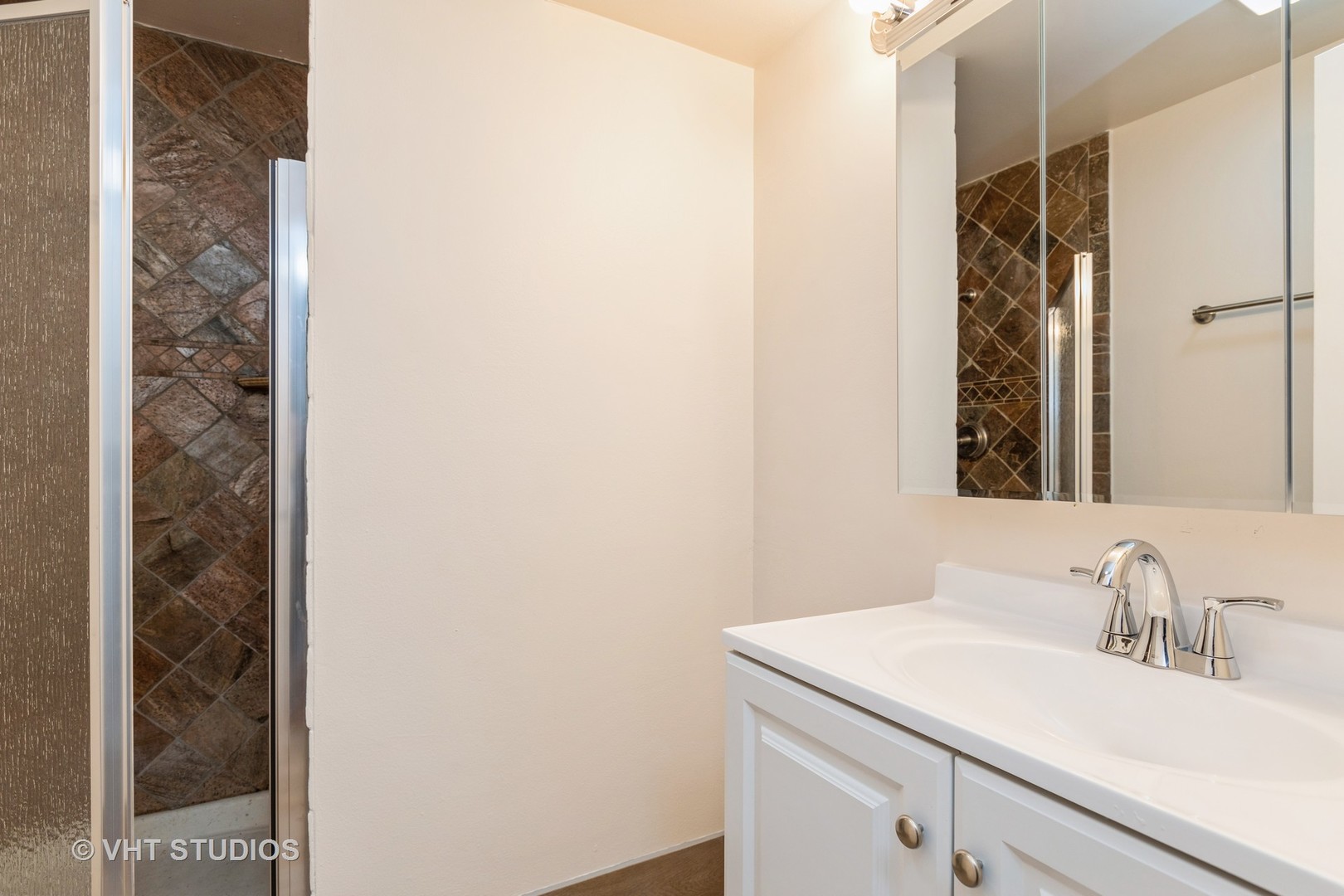 1919 Prairie Square, Unit 133 Schaumburg, IL 60173 - Photo 9 of 14 a bathroom with a sink and a mirror