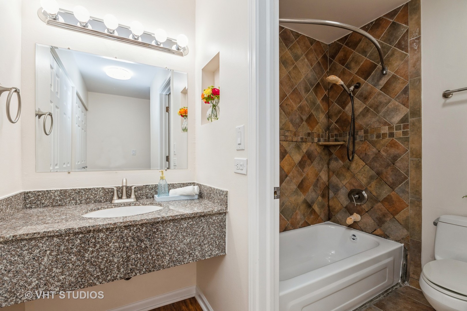 1919 Prairie Square, Unit 133 Schaumburg, IL 60173 - Photo 10 of 14 a bathroom with a granite countertop sink a toilet and shower