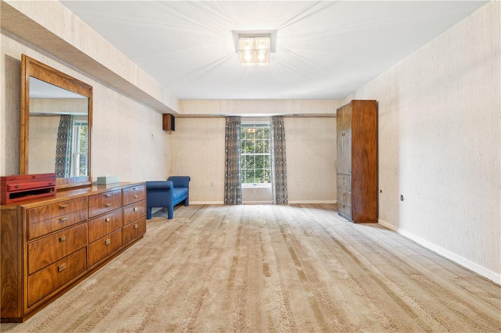 302 Fox Chapel Road, Unit 401 Pittsburgh, PA 15238 - Photo 11 of 25 a spacious bedroom with a bed and a dresser next to a window