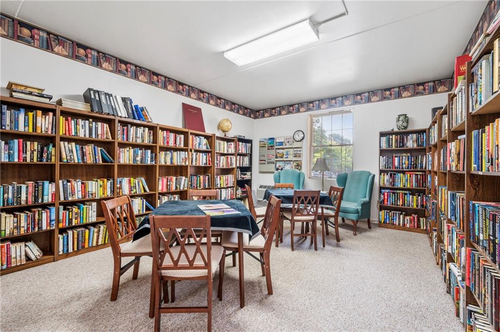 302 Fox Chapel Road, Unit 401 Pittsburgh, PA 15238 - Photo 22 of 25 a dining room with furniture and a book shelf
