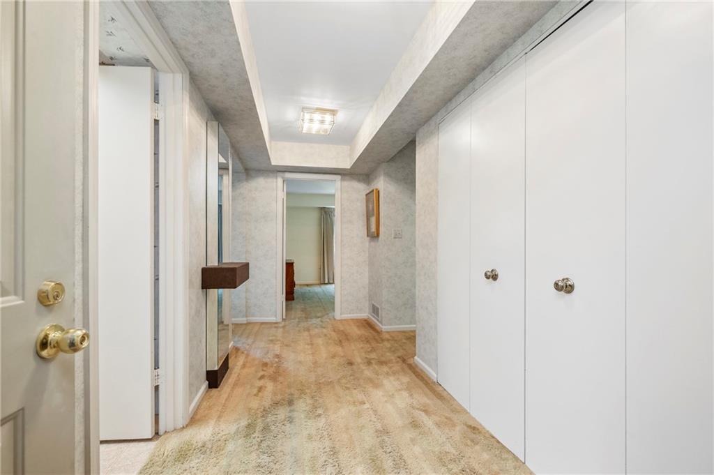 302 Fox Chapel Road, Unit 401 Pittsburgh, PA 15238 - Photo 3 of 25 a view of a hallway with wooden floor and a bathroom