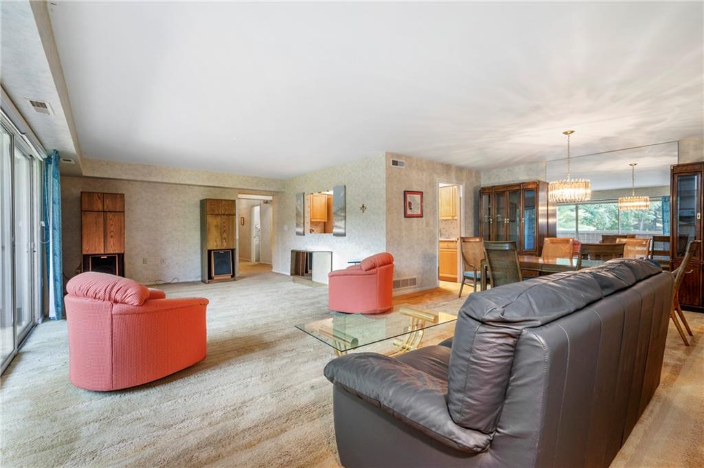 302 Fox Chapel Road, Unit 401 Pittsburgh, PA 15238 - Photo 4 of 25 a living room with furniture and a wooden floor