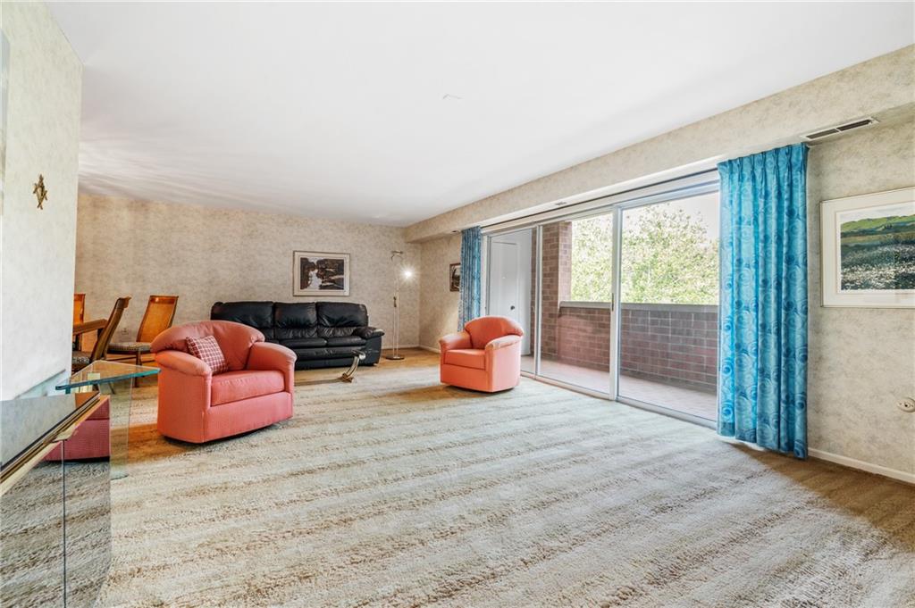 302 Fox Chapel Road, Unit 401 Pittsburgh, PA 15238 - Photo 5 of 25 a bedroom with furniture and a large window