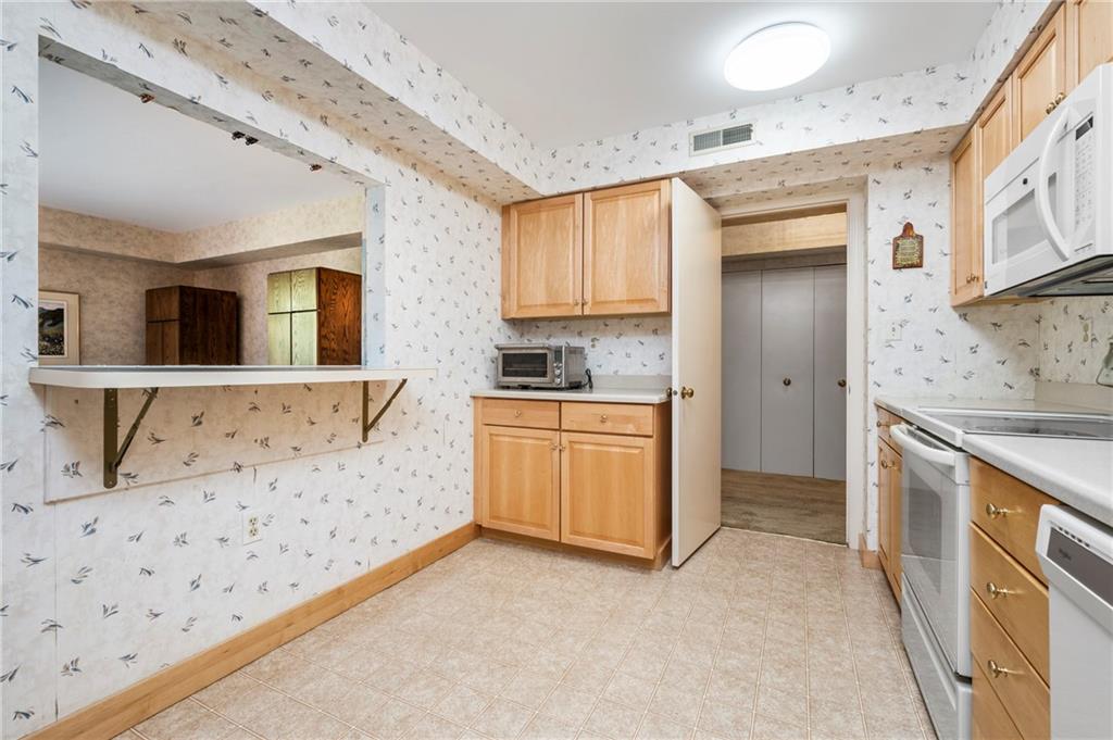 302 Fox Chapel Road, Unit 401 Pittsburgh, PA 15238 - Photo 8 of 25 a kitchen with granite countertop a sink and a stove top oven