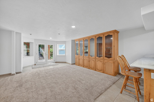 883 East 700 South Springville, UT 84663 - Photo 36 of 59 Expansive room featuring light-toned carpeting, a built-in wood cabinetry unit with glass-front doors, and recessed lighting