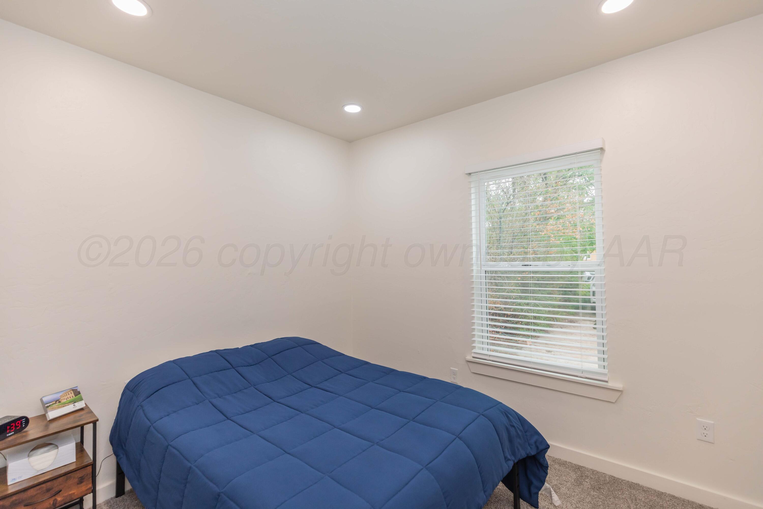 504 High Street Claude, TX 79019 - Photo 9 of 39 a bedroom with a bed and a window
