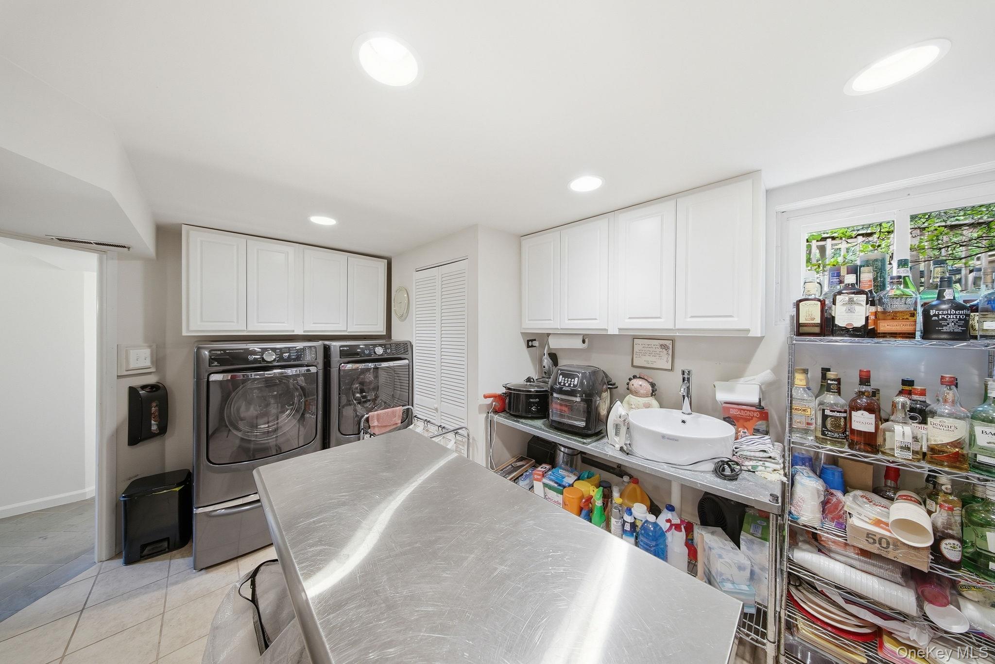172 Wards Road Livingston Manor, NY 12758 - Photo 43 of 47 Functional laundry 2nd Kitchen area featuring white upper cabinetry and a stainless steel prep island
