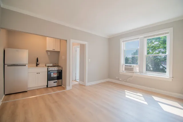 an empty room with windows and closet