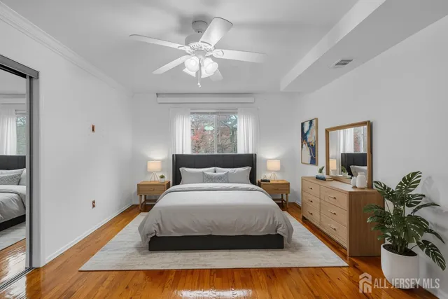 a bedroom with a large bed and a chandelier
