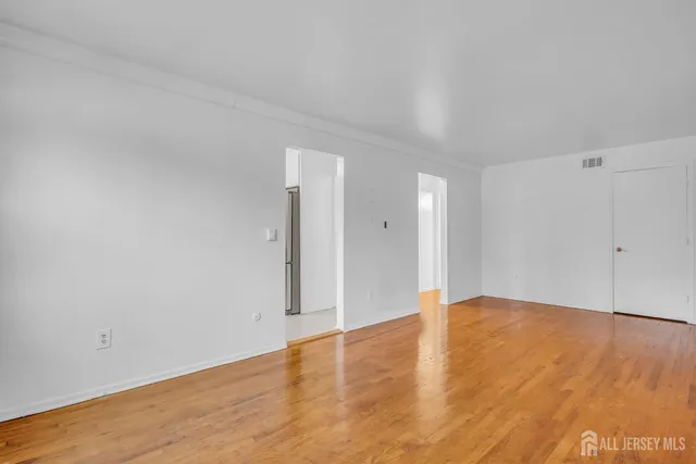 a view of an empty room and wooden floor
