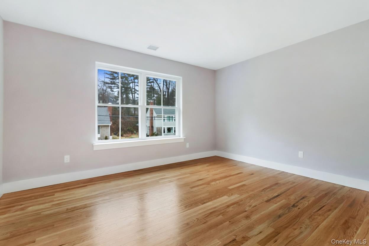 800 Sleepy Hollow Road Briarcliff Manor, NY 10510 - Photo 14 of 15 a view of an empty room with wooden floor and a window