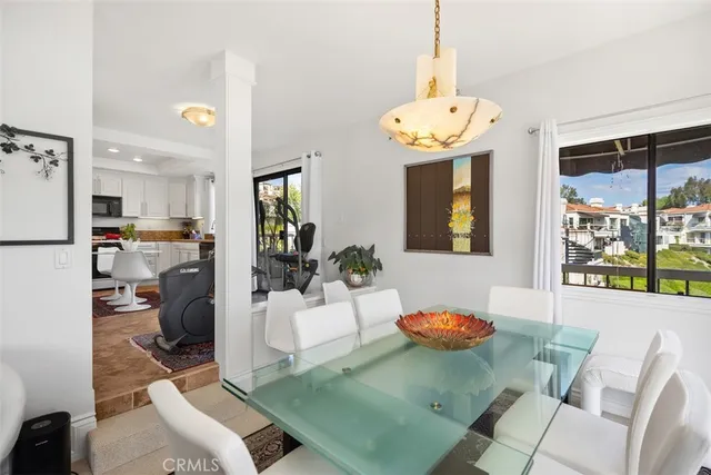 a living room with furniture a chandelier and a table