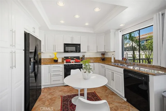 a kitchen with sink refrigerator and stove