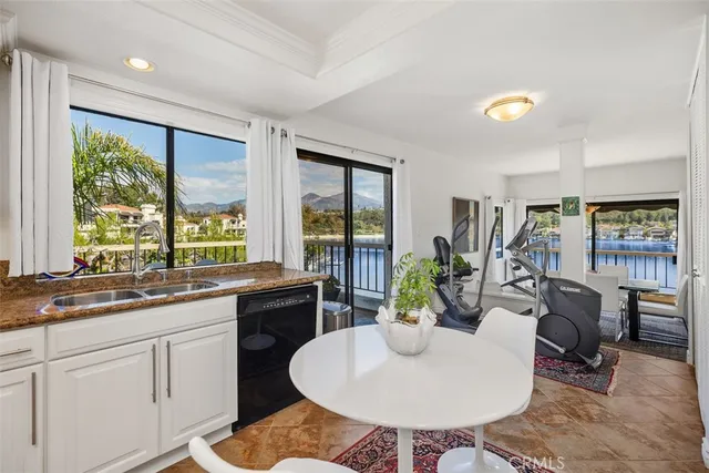 a kitchen with a table chairs sink and cabinets