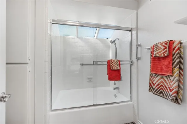 a bathroom with a bathtub and shower