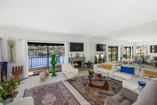 a living room with furniture flat screen tv and a fireplace