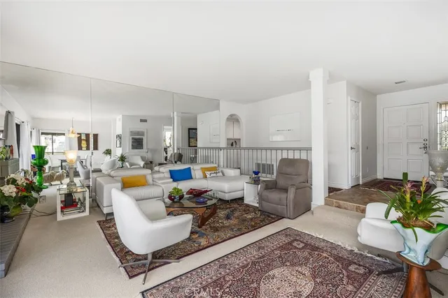 a living room with furniture and a dining table