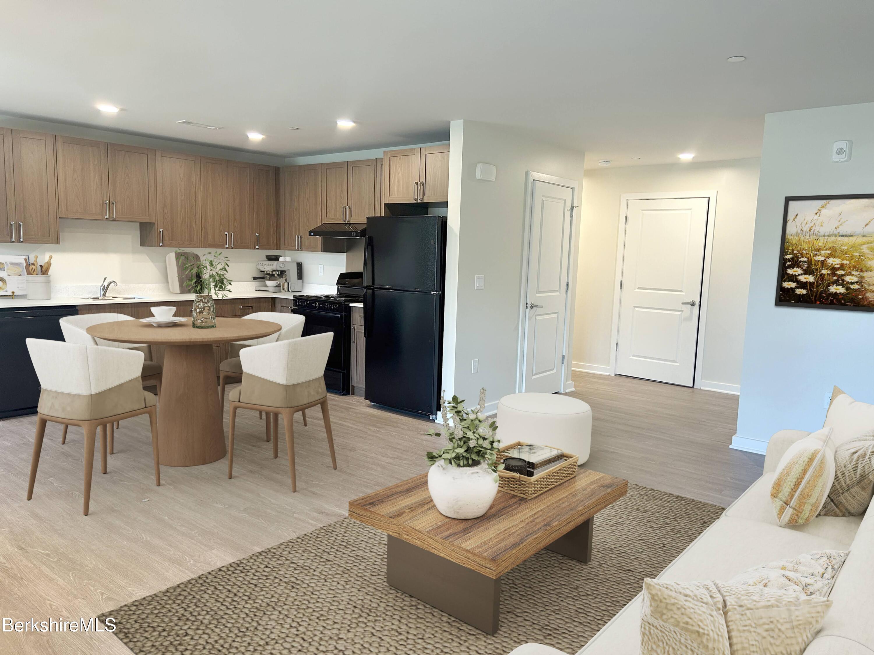 9 Brushwood Way, Unit 9 Lenox, MA 01240 - Photo 1 of 15 a living room with stainless steel appliances kitchen island granite countertop a couch and a coffee table