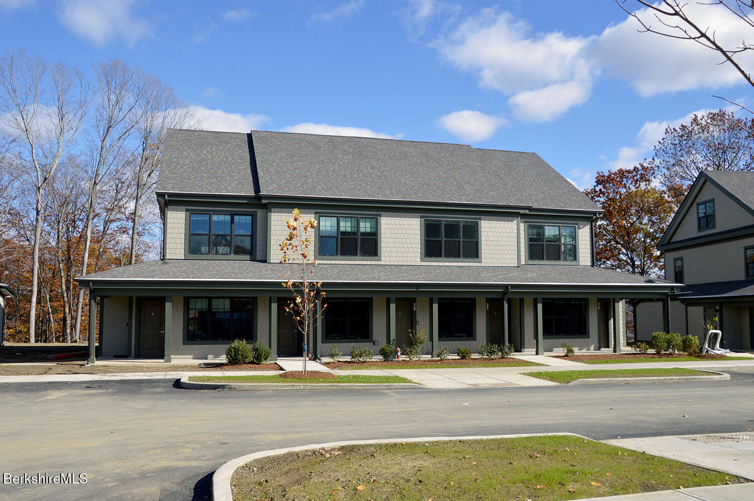 9 Brushwood Way, Unit 9 Lenox, MA 01240 - Photo 14 of 15 a front view of a house with swimming pool and outdoor seating