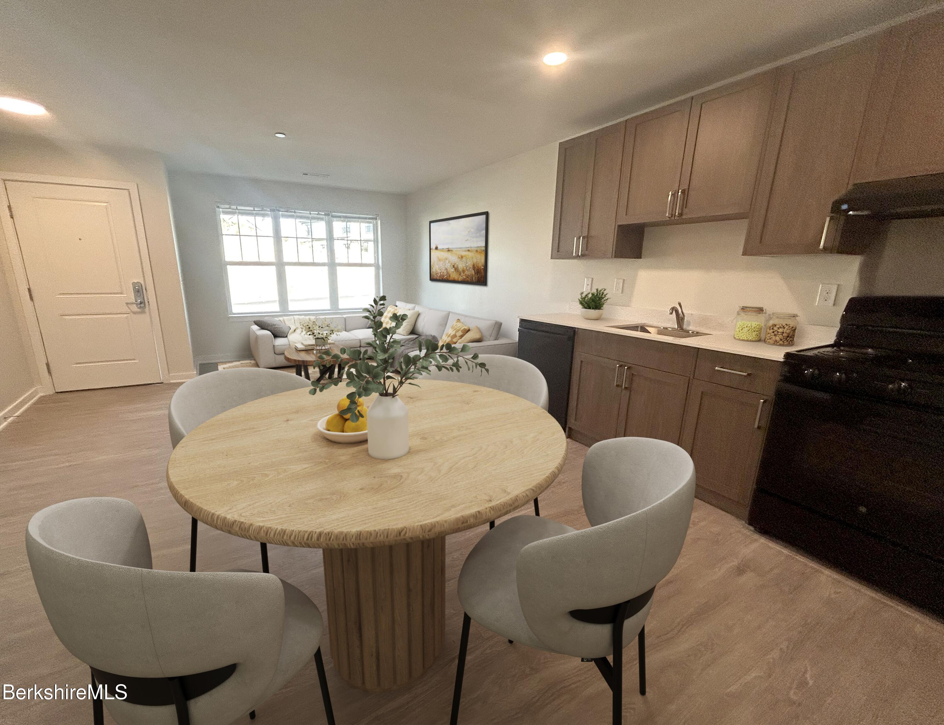 9 Brushwood Way, Unit 9 Lenox, MA 01240 - Photo 5 of 15 a kitchen with a dining table and chairs