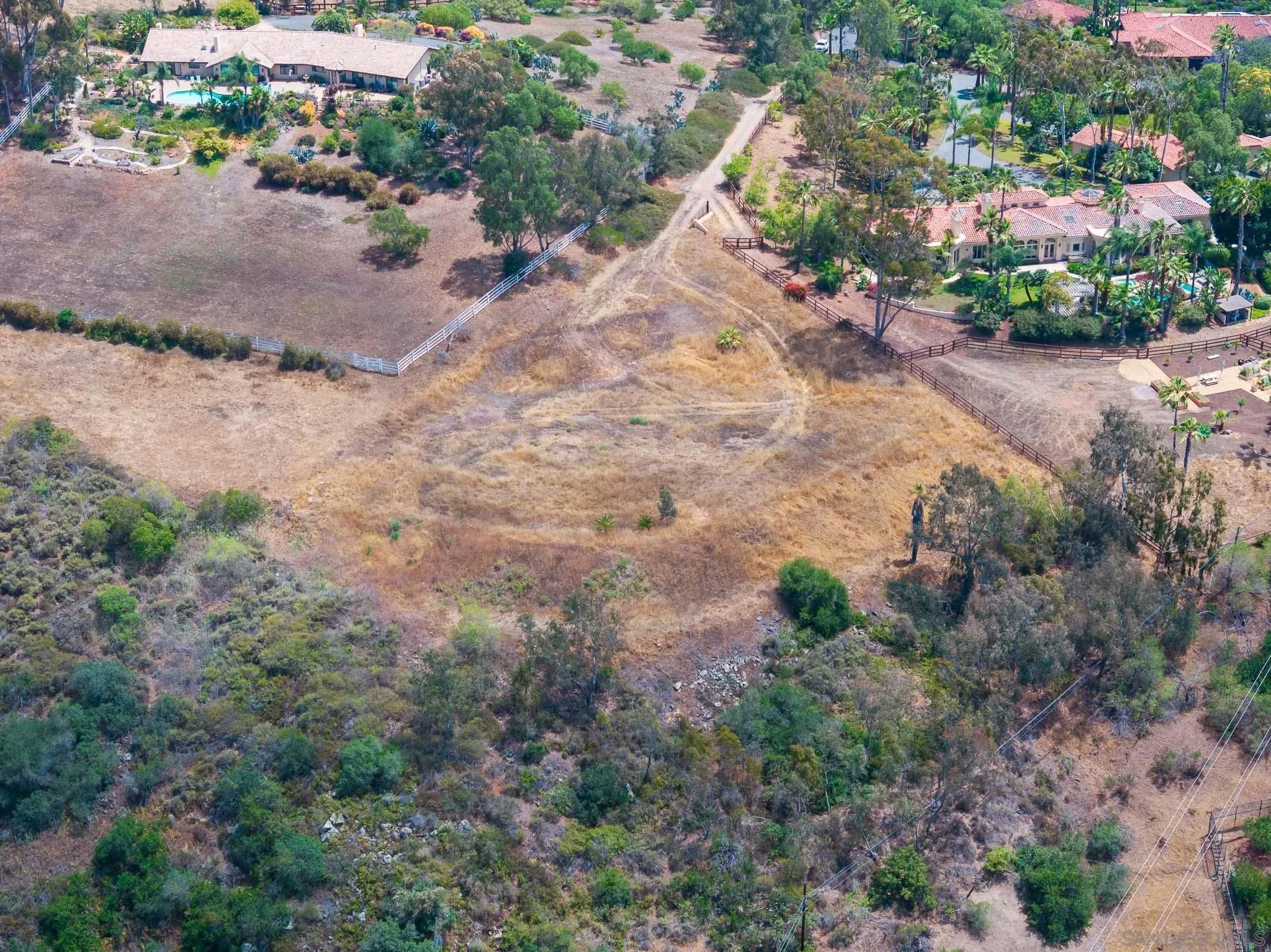 18096 Loma Alegre, Unit 15033 Rancho Santa Fe, CA 92067 - Photo 7 of 12 a view of a dry yard with lots of trees