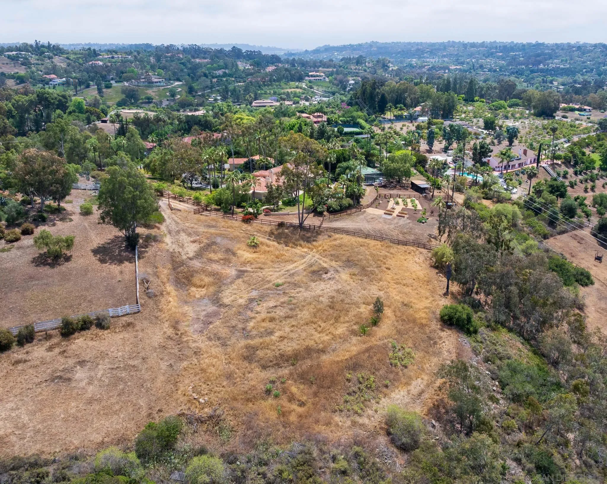 18096 Loma Alegre, Unit 15033 Rancho Santa Fe, CA 92067 - Photo 9 of 12 a view of a dry yard with mountains in the background