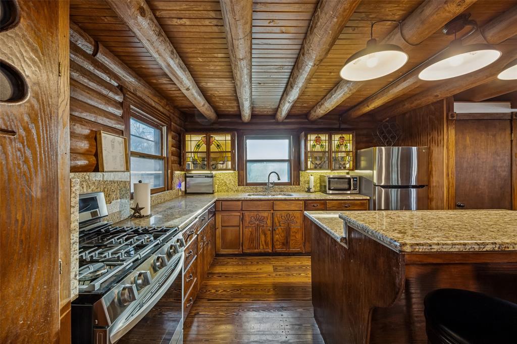 2821 Sachse Road Wylie, TX 75098 - Photo 13 of 38 a kitchen with stainless steel appliances granite countertop a stove a sink and a refrigerator