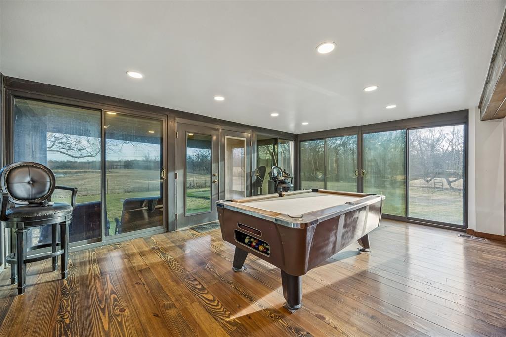 2821 Sachse Road Wylie, TX 75098 - Photo 19 of 38 a room with wooden floor pool table and windows