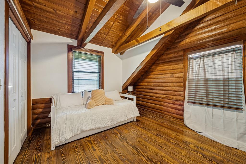 2821 Sachse Road Wylie, TX 75098 - Photo 23 of 38 a bedroom with wooden floors and a bed