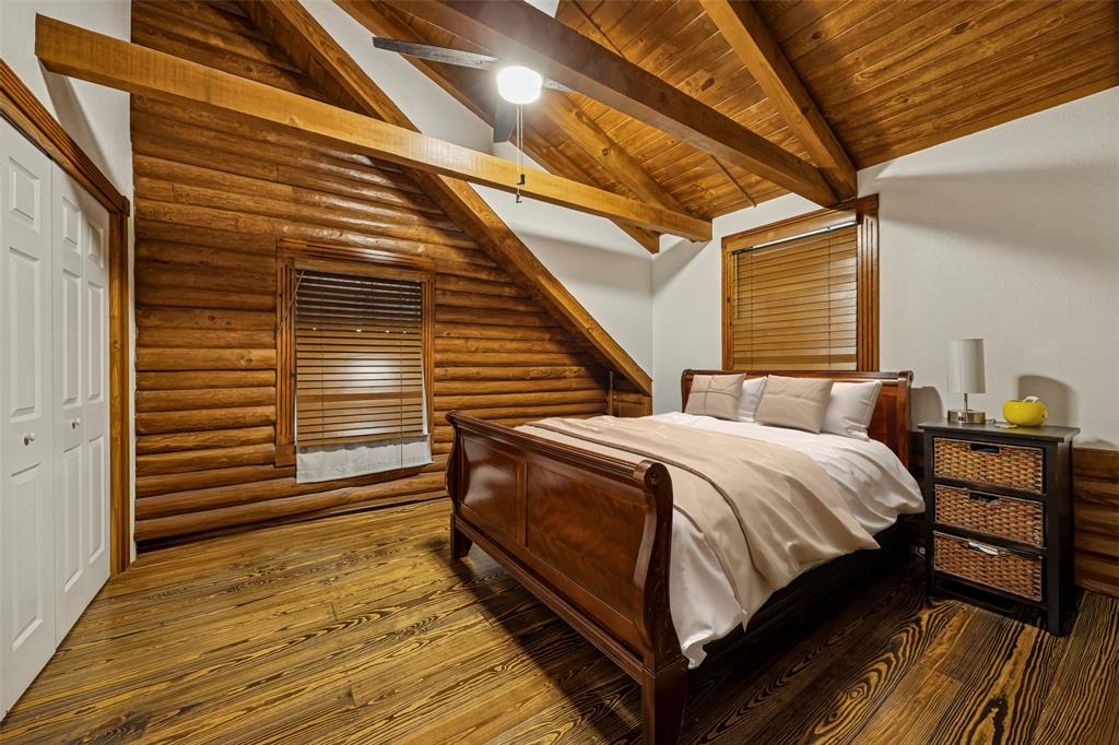 2821 Sachse Road Wylie, TX 75098 - Photo 25 of 38 a spacious bedroom with a bed and wooden floor