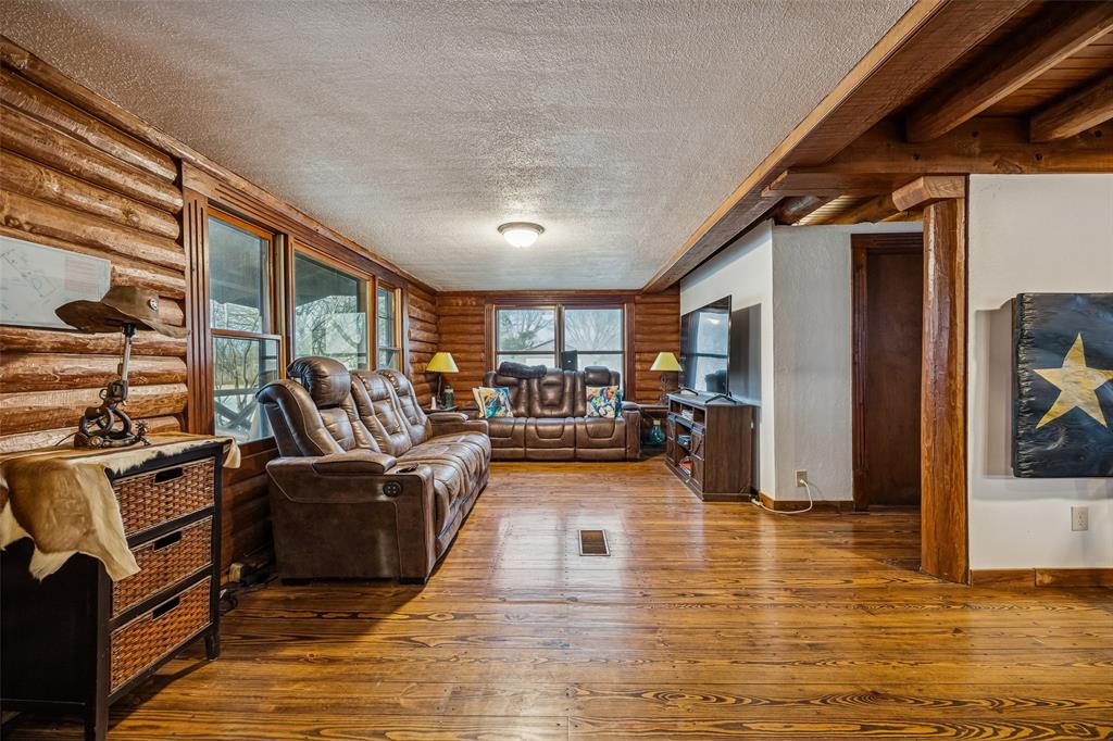 2821 Sachse Road Wylie, TX 75098 - Photo 10 of 38 a living room with furniture window and a wooden floor