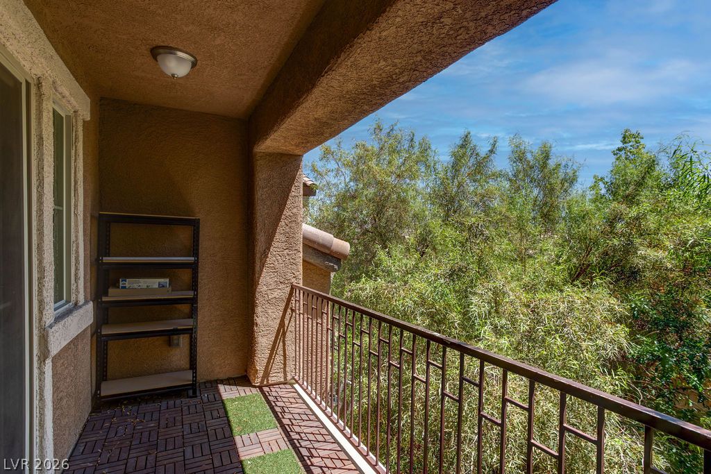 7724 Vibrant Thread Court Las Vegas, NV 89149 - Photo 35 of 43 A private balcony offers serene outdoor relaxation with lush green views.