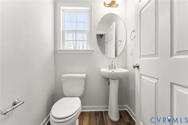 a bathroom with a toilet a sink and mirror