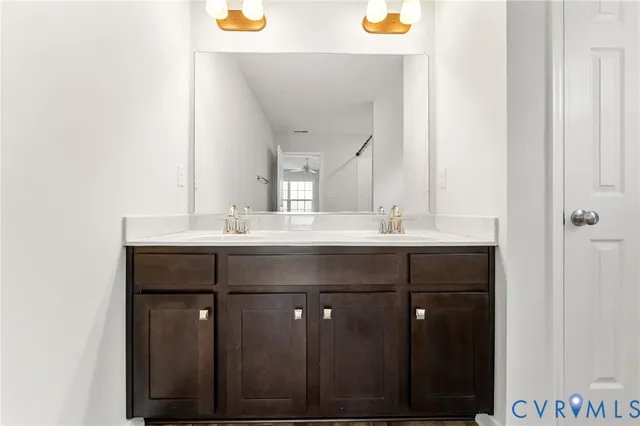 a bathroom with a sink vanity and a mirror