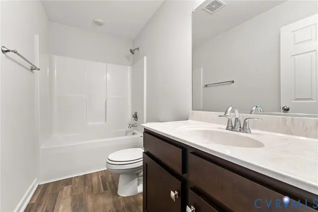 a bathroom with a sink a toilet and a large mirror