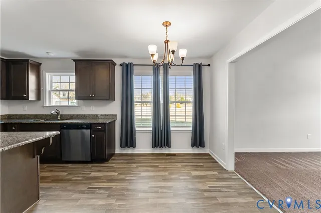 a kitchen with stainless steel appliances granite countertop a stove and a sink