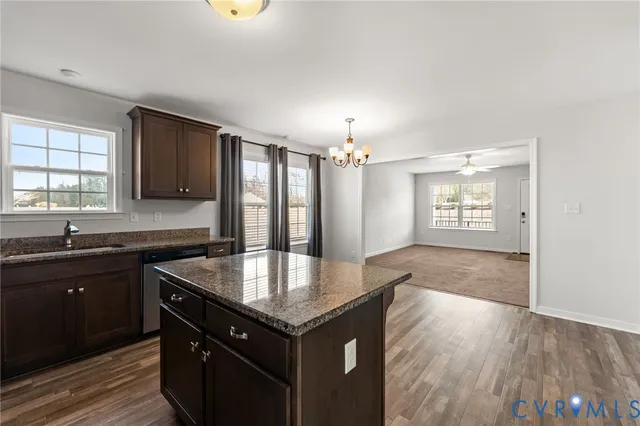 a kitchen with granite countertop a stove and a sink