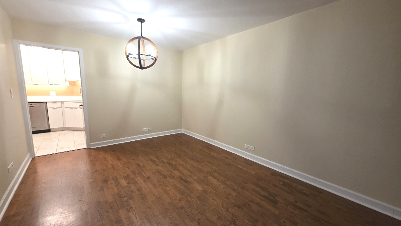 6033 North Sheridan Road, Unit 5G Chicago, IL 60660 - Photo 3 of 24 a view of room with wooden floor and window