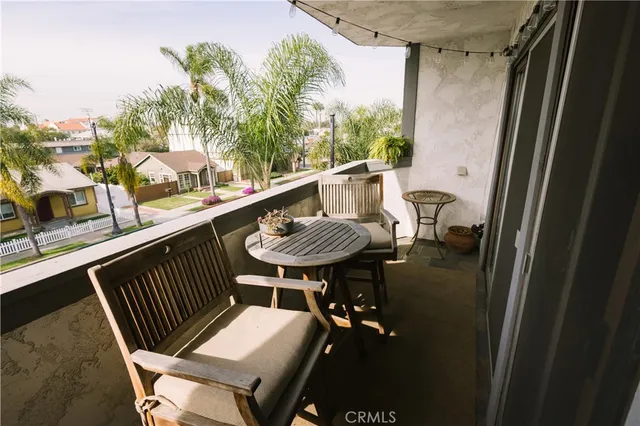 a balcony with table and chairs