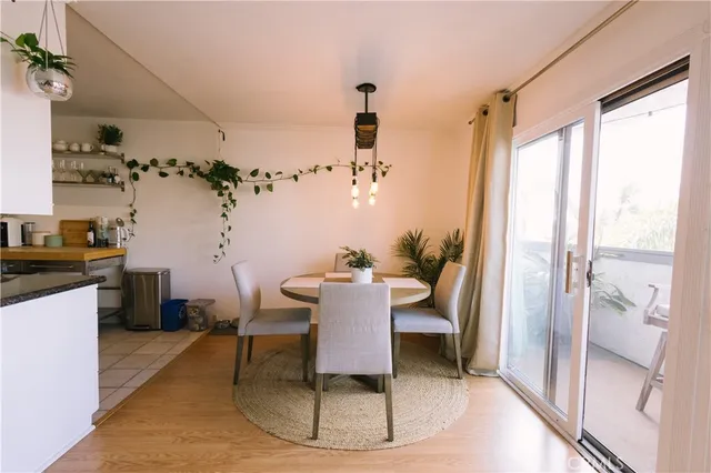 a view of a dining room with furniture a chandelier and wooden floor