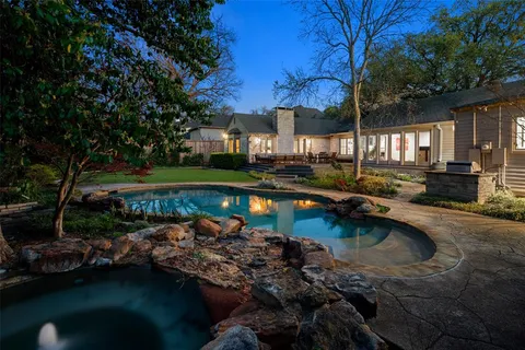 a view of a lake with a house and a yard