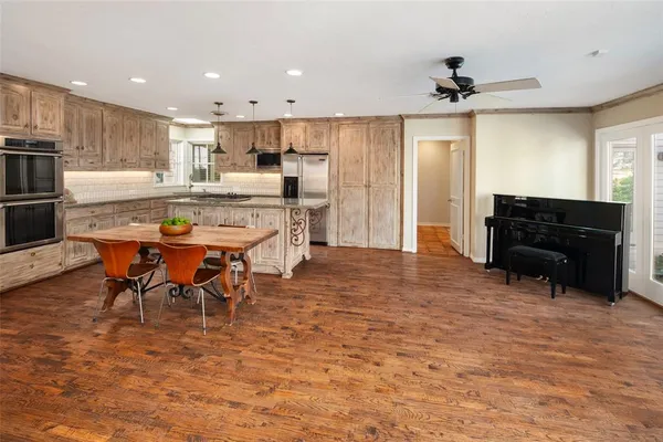 a large kitchen with a table and chairs