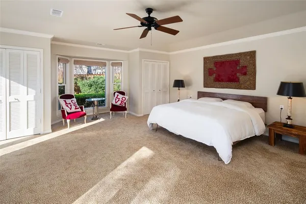 a bedroom with a bed and a large window